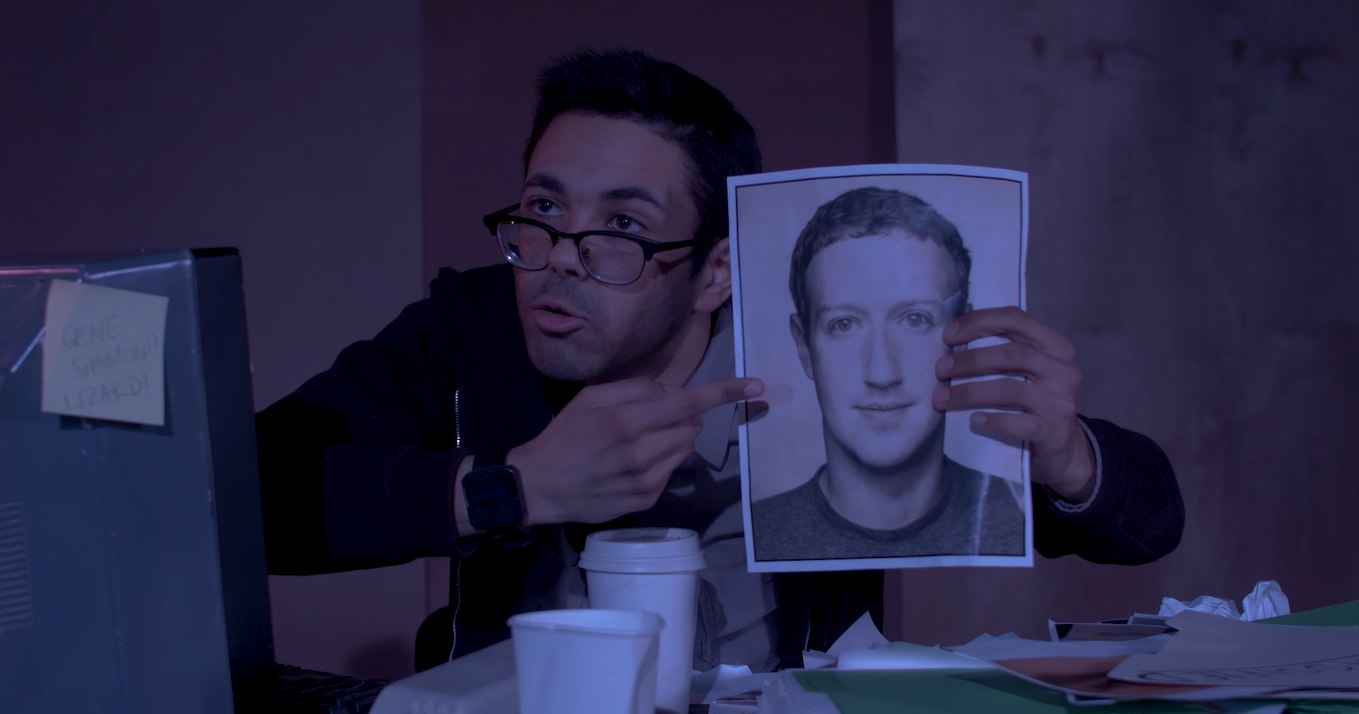 Still from &ldquo;Cold-Blooded&rdquo; - Nerman holding up a printed photo at his desk